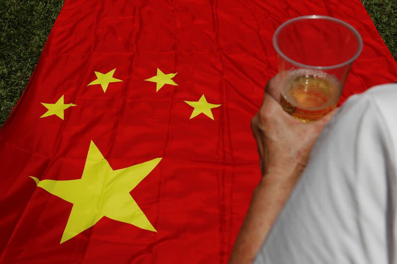 A pro-China supporter celebrates with champagne after China's parliament passes national security law for Hong Kong, in Hong Kong