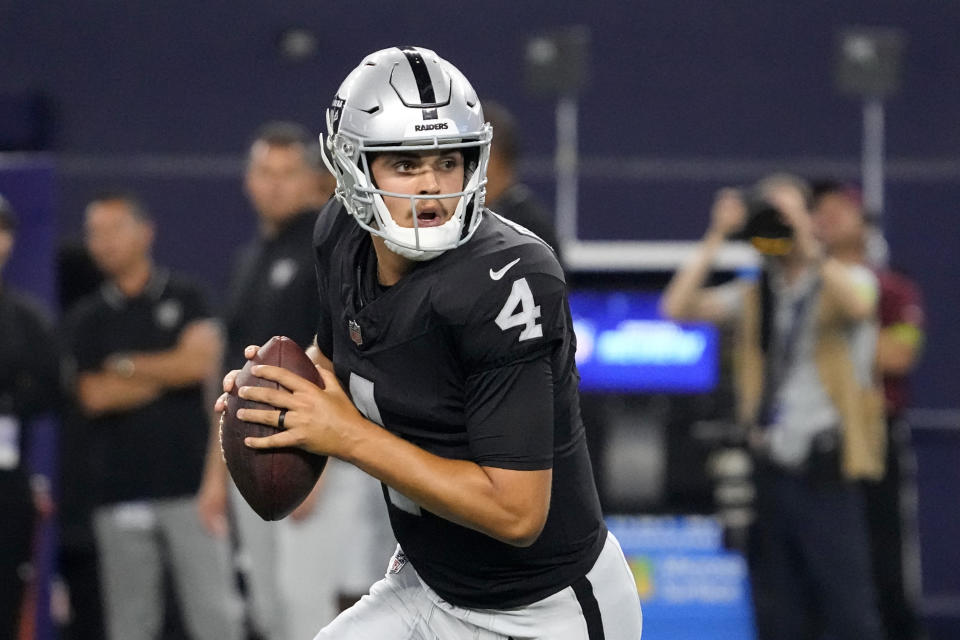 Las Vegas Raiders quarterback Aidan O'Connell (4) rolls out of the pocket before throwing a pass in the secod half of a preseason NFL football game against the Dallas Cowboys in Arlington, Texas, Saturday, Aug. 26, 2023. (AP Photo/Sam Hodde)