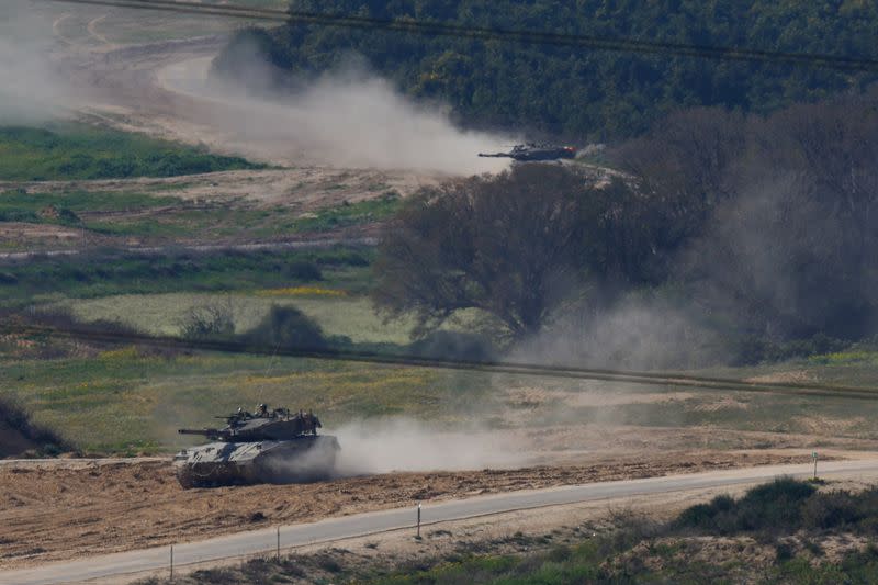 Israeli tanks manoeuvre near the Israel-Gaza border, as seen from Israel