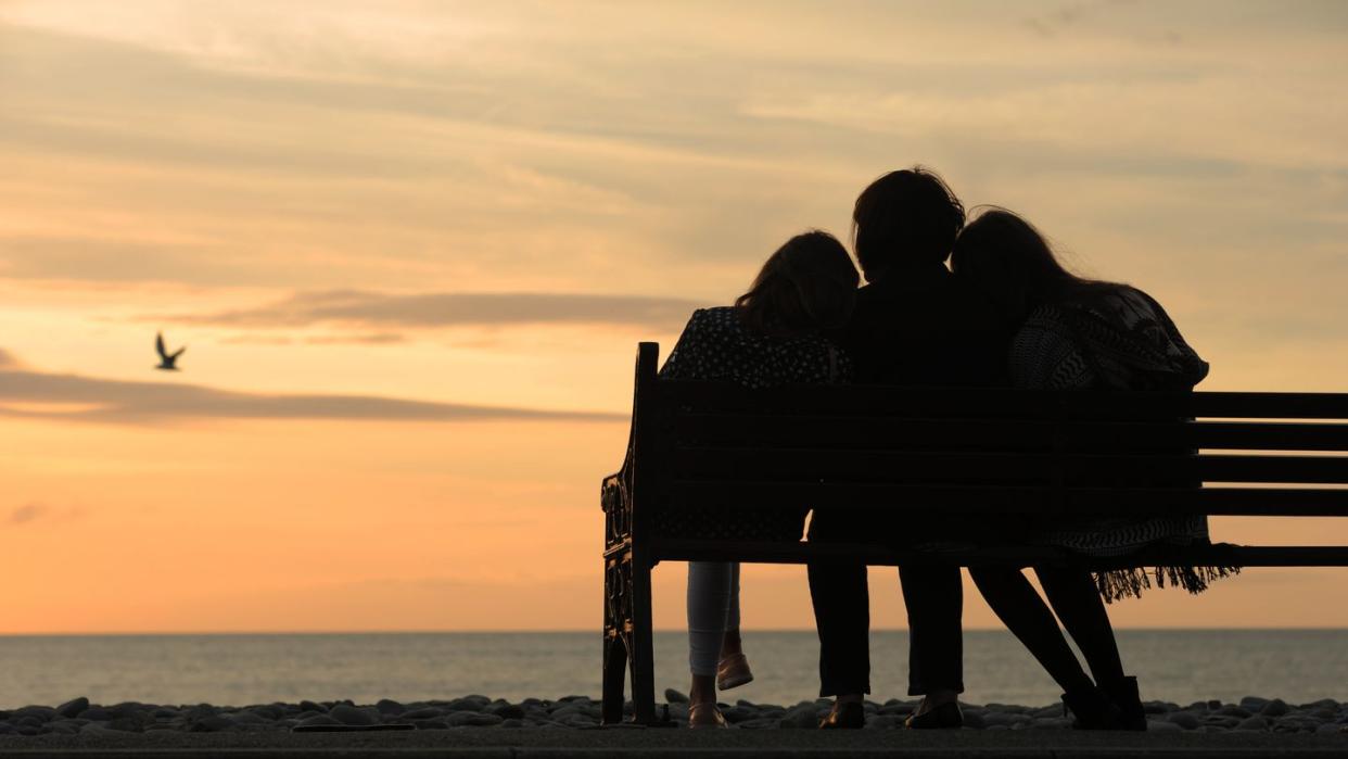 mother and children watching sunset