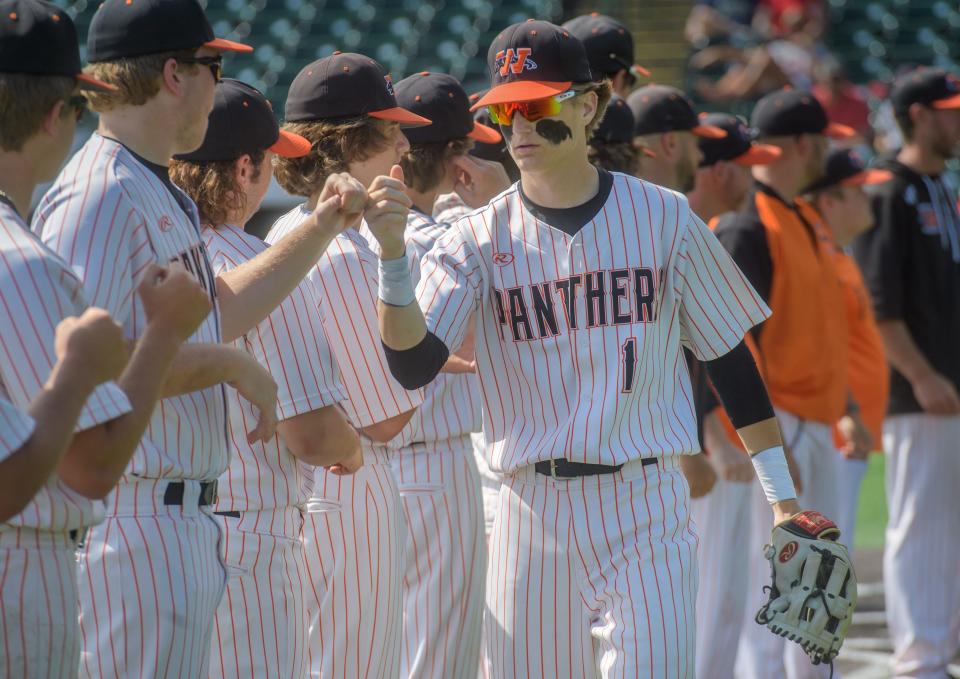 Washington's Caleb Wudtke fist bumps his teammates during player introductions before the start of the Panthers' Class 3A state baseball semifinal against Chatham Glenwood on Friday, June 10, 2022 at Duly Health & Care Field in Joliet.