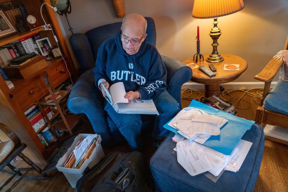 Marty Weyand shows papers and documents he accumulated while working through guardianship issues placed on his late father by the nursing home where he lived. Photo taken Tuesday, March 19, 2024 at his home in Speedway.