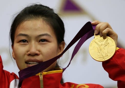 China's world number one Yi Siling won the first gold of the London Olympics in the women's 10m air rifle competition at London's Royal Artillery Barracks on Saturday. In a tense contest Poland's Sylwia Bogacka took silver while Yu Dan of China won bronze. Yi, who won the title in the event at the 2010 world championships in Munich, had a total winning score of 502.9, 0.7 points ahead of Bogacka