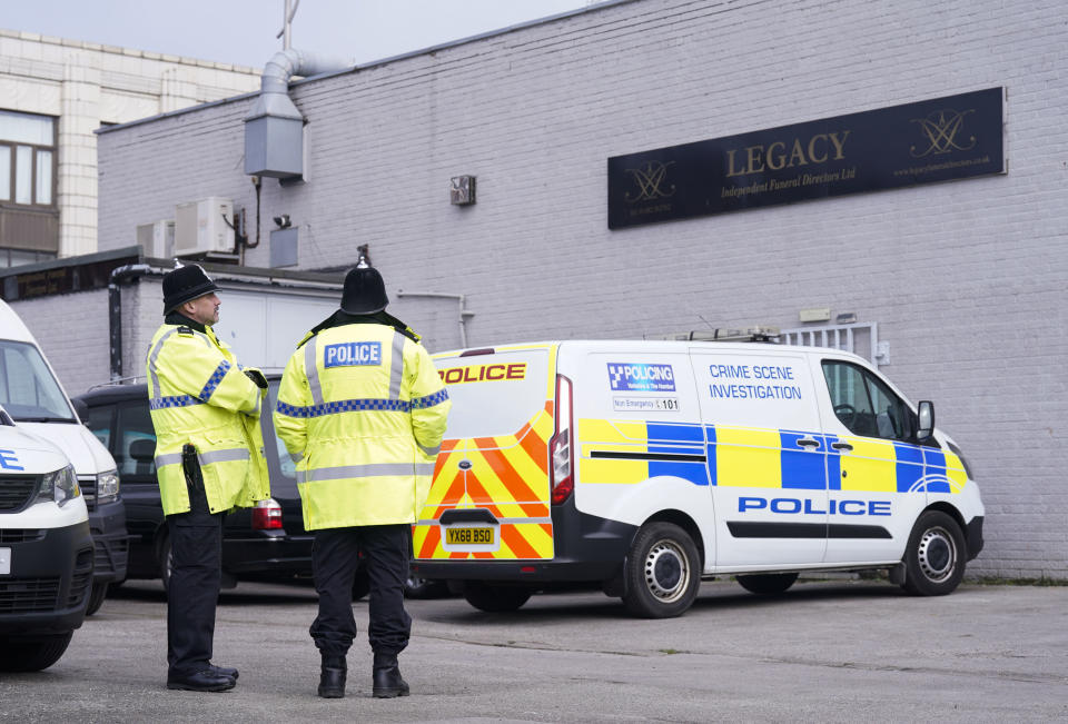 Police stand outside the Hessle Road branch of Legacy Independent Funeral Directors in Hull, England, Saturday, March 9, 2024. Police in northern England say they have removed 34 bodies from a funeral home and arrested a man and woman on suspicion of fraud and preventing lawful burials. The arrests Sunday follow several days of investigation at Legacy Funeral Directors in Hull and two related funeral homes. (Danny Lawson/PA via AP)