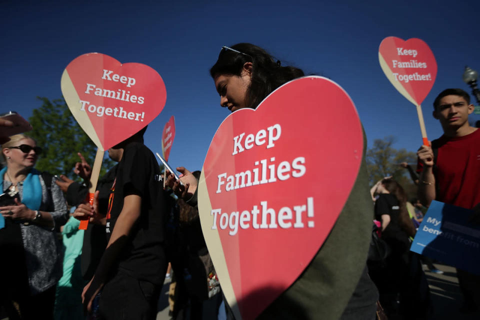 Pro-immigration activists hold signs