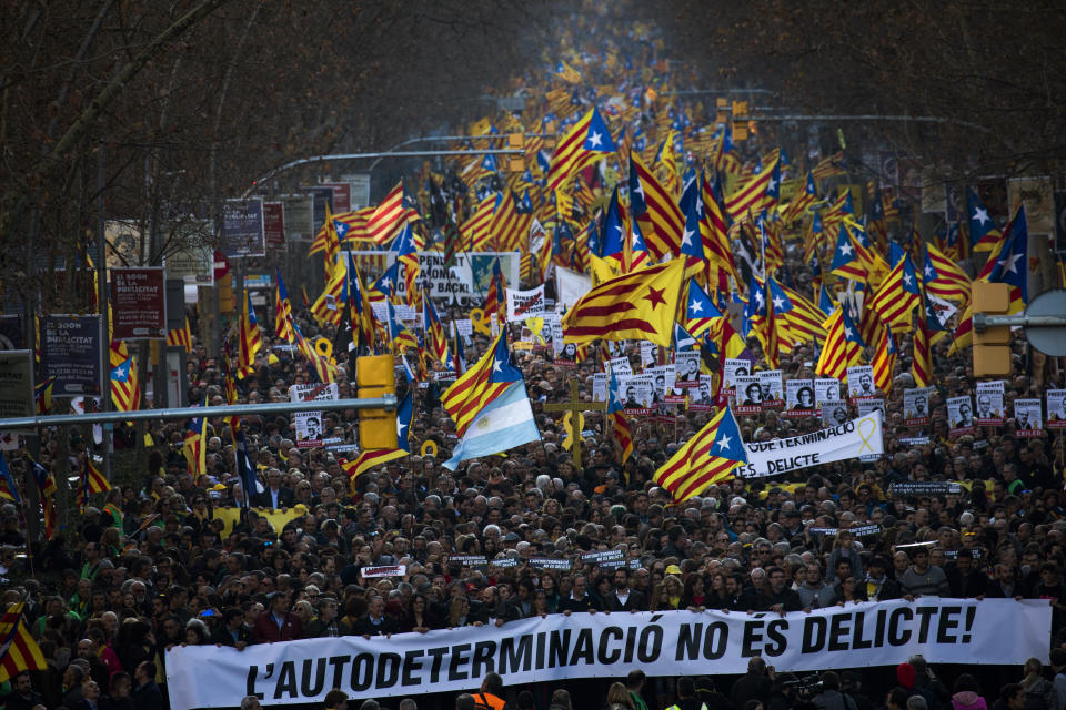 Pro independence demonstrators march waving esteladas or independence flags, during a demonstration supporting the imprisoned pro-independence political leaders in Barcelona, Spain, Saturday, Feb. 16, 2019. Thousands of Catalan separatists are marching in Barcelona to proclaim the innocence of 12 of their leaders who are on trial for their role in a failed 2017 secession bid. (AP Photo/Emilio Morenatti)