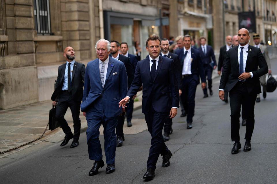 Britain's King Charles III (left) and French President Emmanuel Macron walk in the street from the Elysee Palace to the British Ambassador's residence in Paris on the first day of a state visit to France.