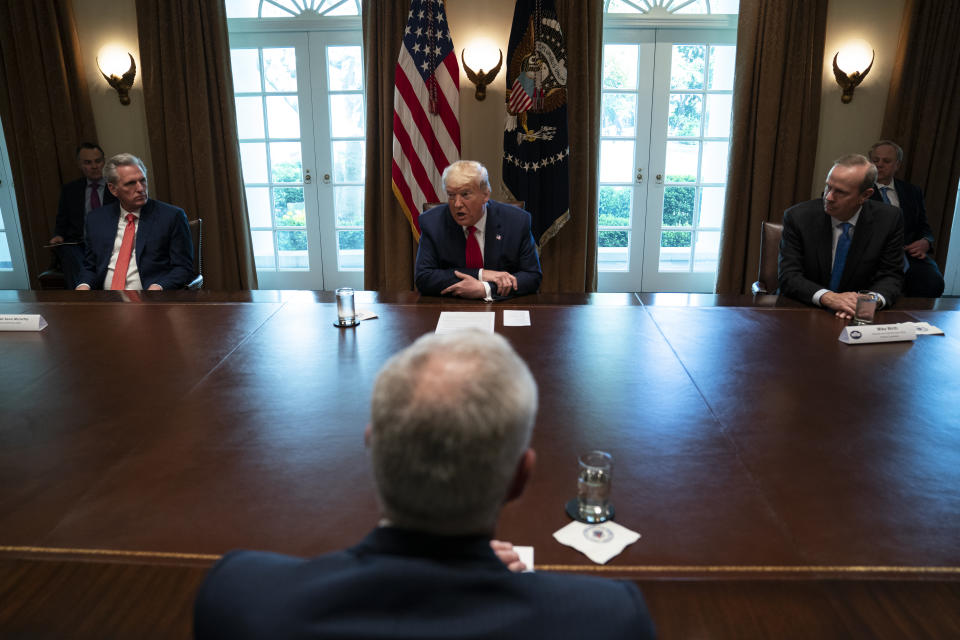 House Minority Leader Kevin McCarthy of Calif., left, and Chevron CEO Mike Wirth, right, listen to President Donald Trump speak during a meeting with energy sector business leaders in the Cabinet Room of the White House, Friday, April 3, 2020, in Washington. (AP Photo/Evan Vucci)