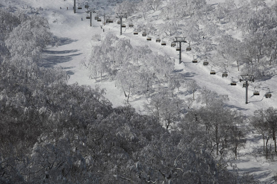 Chairlifts transport skiers at a ski resort Feb. 5, 2020, in Niseko, Hokkaido, Japan. (AP Photo/Jae C. Hong)