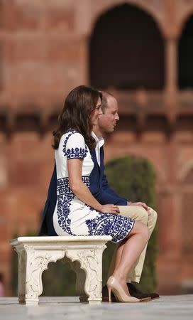 Britain's Prince William and his wife Catherine, the Duchess of Cambridge, sit as they pose at the Taj Mahal in Agra, India, April 16, 2016. REUTERS/Adnan Abidi