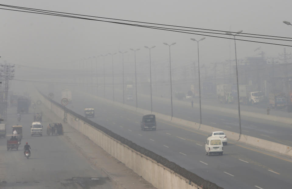 Vehicles drive on a highway as smog envelops the area of Lahore, Pakistan, Wednesday, Nov. 11, 2020. People in Pakistan’s cultural capital of Lahore were at risk of respiratory diseases and eye-related problems Wednesday after the air quality deteriorated to hazardous levels due to a quilt of smog over the city, prompting doctors to urge people to stay at home. (AP Photo/K.M. Chaudary)