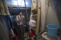Salesman Li Chenghui looks cramped in his tiny apartment (Rex)