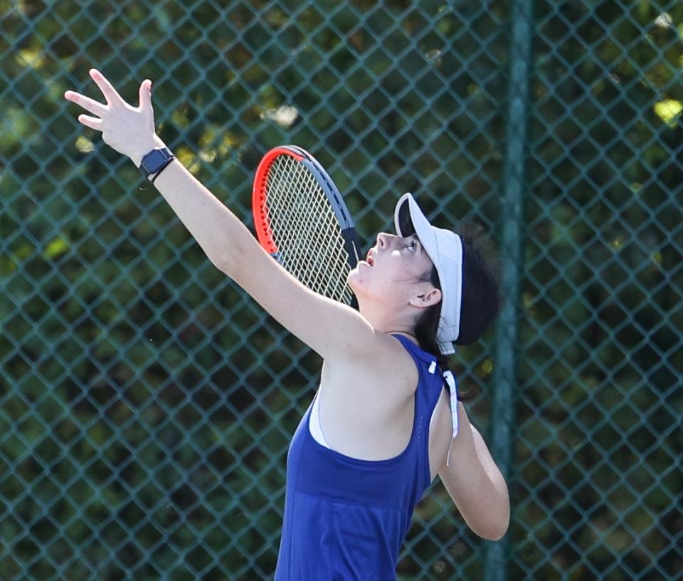 Wooster's Minnie Pozefsky watches the ball come down as she prepares to crush this serve in her second round sectional battle.