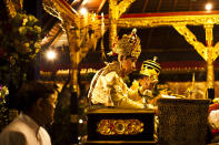 UBUD, BALI, INDONESIA - AUGUST 17: Priests gives a blessing to wake up the soul of the deceased prior to the cremation of Anak Agung Niang Rai - also know as the Pengabenan - for the late Anak Agung Niang Rai, mother of Gianyar Regent, Tjokorda Oka Artha Ardana Sukawati, at Puri Ubud in Gianyar Bali on August 17, 2011 in Ubud, Bali, Indonesia. Niang Rai died in a Denpasar hospital in May; her actual cremation will take place on August 18 and will involve a nine level, 24m high 'bade' or body carring tower, made by upto 100 volunteers from 14 local villages. It will be carried to the cremation by 4500 Ubud residents. (Photo by Ulet Ifansasti/Getty Images)