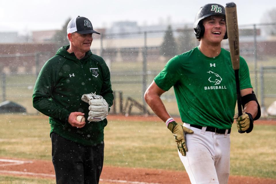 Fossil Ridge head baseball coach Marc Wagner jokes with a player during a practice on April 10 at Fossil Ridge High School in Fort Collins.