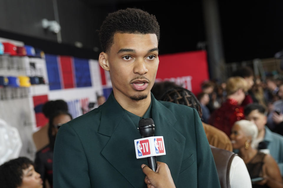 Victor Wembanyama answers questions for the media upon arriving at Barclays Center before the NBA basketball draft Thursday, June 22, 2023, in New York. (AP Photo/John Minchillo)