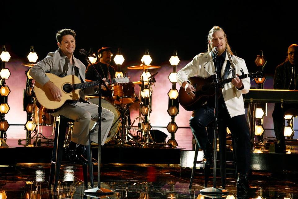 Huntley, right, joined musical forces with his coach Horan for an earnest acoustic rendition of “Knockin’ on Heaven’s Door” by Bob Dylan.