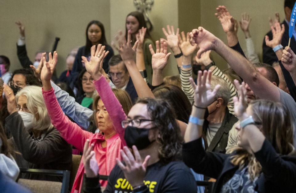 Audience members show support for for a speaker against the proposed Poseidon desalination plant