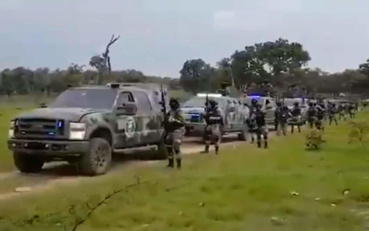 The military uniforms are emblazoned with the acronym for the New Generation Jalisco Cartel, a powerful crime organisation