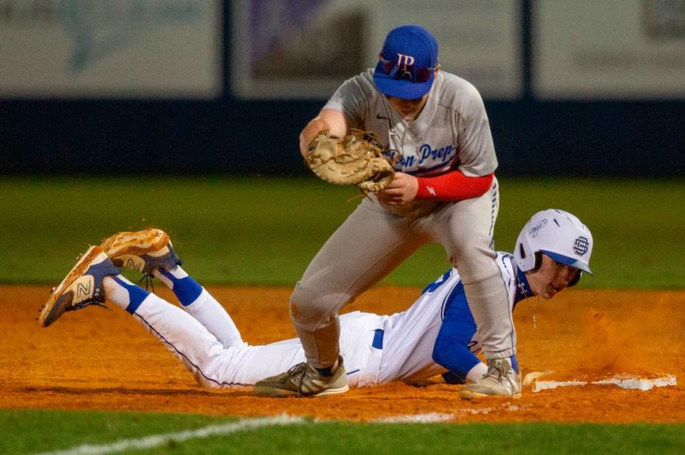 Ocean Springs’ AJ Rossi slides back to first base during a game against Jackson Prep in Ocean Springs on Monday, March 11, 2024.