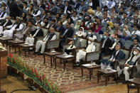 Afghan President Ashraf Ghani, third right, wears a protective face mask to help curb the spread of the coronavirus, attend on the last day of an Afghan Loya Jirga or traditional council, in Kabul, Afghanistan, Sunday, Aug. 9, 2020. The council concluded Sunday with hundreds of delegates agreeing to free 400 Taliban members, paving the way for an early start to negotiations between Afghanistan's warring sides. (AP Photo)