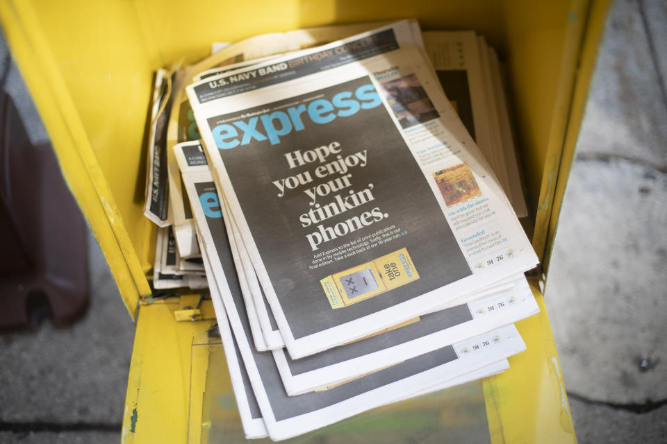 Final copies of the free commuter paper, Express, are seen in a newspaper box outside McPherson Square Metro Station in downtown Washington, Thursday, Sept. 12, 2019. The Washington Post announced yesterday that it has decided to cease publication of its Express commuter paper, that has been handed out for free at Metro stations for 16 years. (AP Photo/Pablo Martinez Monsivais)