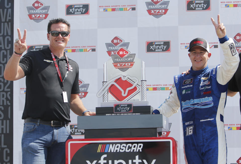 FILE - In this Saturday, June 5, 2021, file photo, car owner Matt Kaulig, left, celebrates with A.J. Allmendinger in Victory Lane after winning the NASCAR Xfinity Series auto race at Mid-Ohio Sports Car Course in Lexington, Ohio. Kaulig Racing has purchased two charters from Spire Motorsports and will move to NASCAR's Cup Series next year with a full-time ride for Justin Haley and select races for AJ Allmendinger. (AP Photo/Tom E. Puskar)