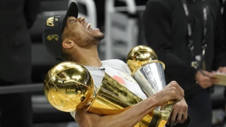 Milwaukee Bucks forward Giannis Antetokounmpo (above) is getting a new star teammate in Damian Lillard. Here, Antetokounmpo holds the NBA Championship trophy (left) and MVP trophy in July 2021 after the Bucks defeated the Phoenix Suns in Game Six of the NBA Finals. (Photo: Paul Sancya/AP)