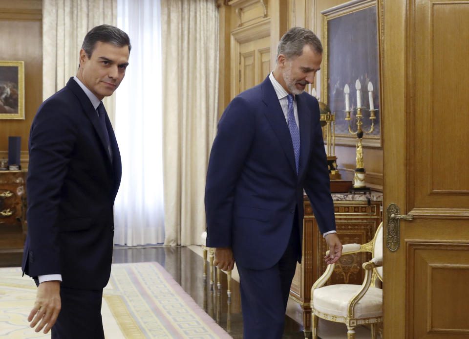 Spain's caretaker Prime Minister Pedro Sanchez, left, follows Spain's King Felipe VI into a meeting at the Zarzuela Palace on the outskirts of Madrid, Spain, Tuesday Sept. 17, 2019. Spain's King Felipe VI is wrapping up two days of talks with political party leaders, hoping he can find a candidate that can win parliament's backing to form a government and avert a second national election this year. (Ballesteros, Pool photo via AP)