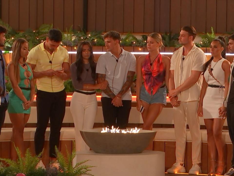 Love Islanders gather around the fire pit during Thursday 30 June’s episode (ITV)