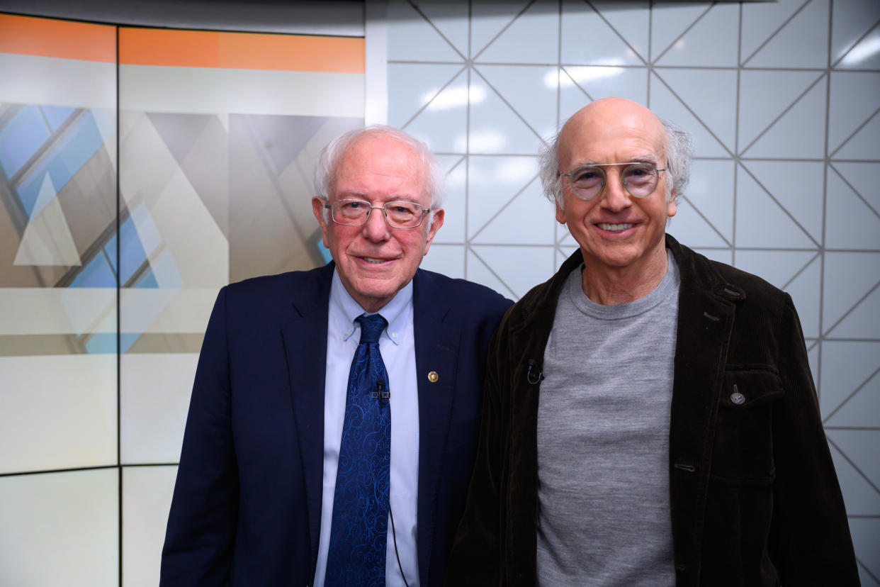 Larry David (R) told the New York Times that Bernie Sanders (L), whom he portrays on Saturday Night Live, should drop out of the presidential race. (Photo: Nathan Congleton/NBC/NBCU Photo Bank via Getty Images)