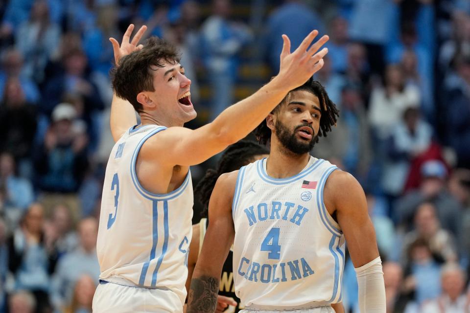 North Carolina guard Cormac Ryan (3) and guard RJ Davis react in the second half against Wake Forest at Dean E. Smith Center.