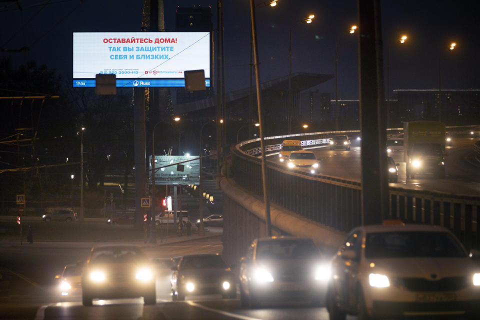 Cars drive past an electronic billboard reading "Stay home, take care of yourself and your loved ones" is displayed in an almost empty Prospect Mira (Peace's Avenue) in Moscow, Russia, Tuesday, April 7, 2020. Putin asked experts whether it would be possible to lift some of the restrictions earlier to ease the pain for the economy. They said next week would show if the lockdown has helped. The new coronavirus causes mild or moderate symptoms for most people, but for some, especially older adults and people with existing health problems, it can cause more severe illness or death. (AP Photo/Alexander Zemlianichenko)