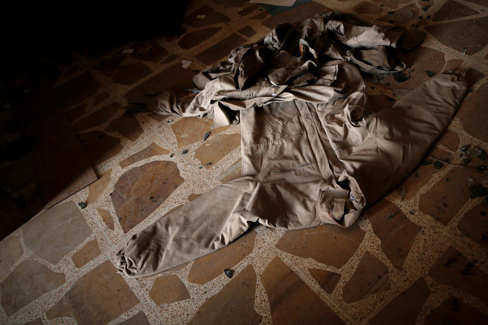 <p>Clothing left behind by Islamic State militants is seen on the floor in a compound used as a prison by Islamic State militants in the 17 Tamuz (July 17) district, in western Mosul, Iraq, June 6, 2017. (Alkis Konstantinidis/Reuters) </p>