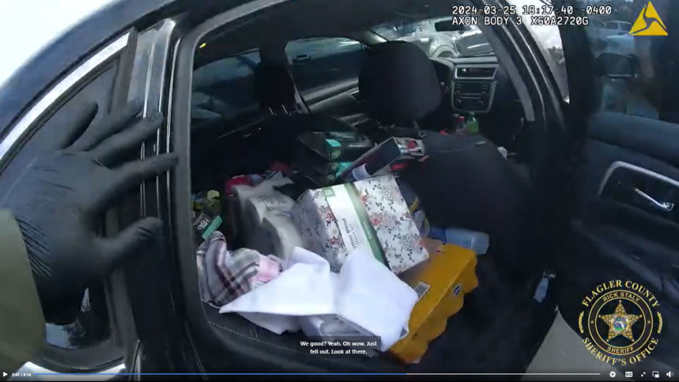 Video shows Walmart merchandise came spilling out of the back of the vehicle when a deputy opened the car door.