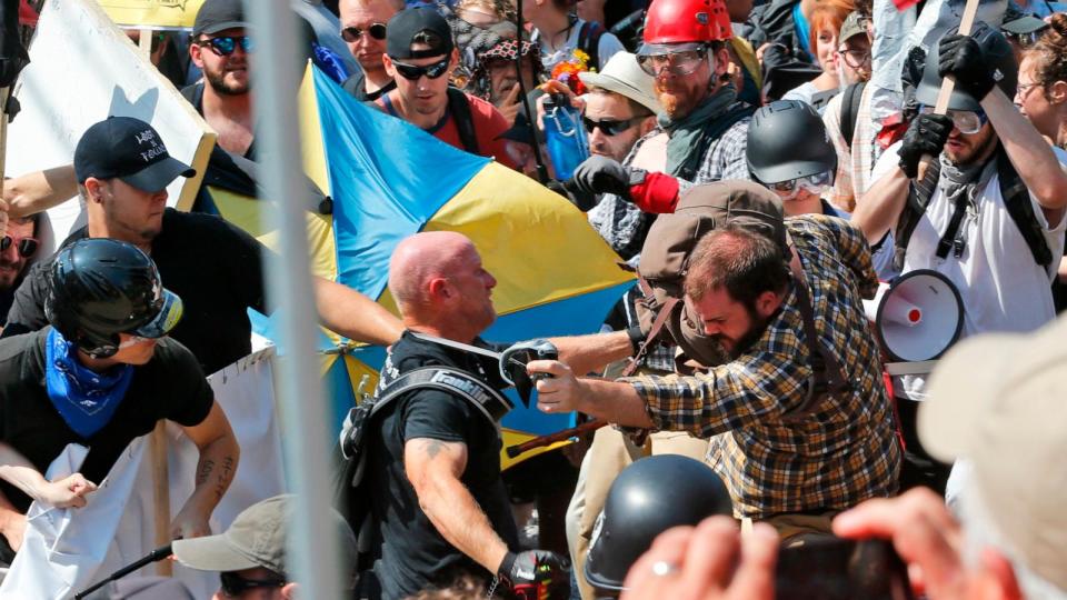 PHOTO: In this Aug. 12, 2017 file photo people clash at the entrance to Lee Park in Charlottesville, Va. (Steve Helber/AP, FILE)