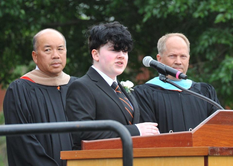 Graduate Leo Breen, center, gives the invocation during the Thayer Academy commencement in Braintree, Saturday, June 11, 2022.