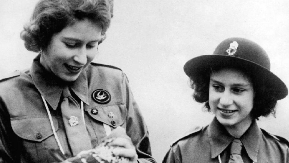 A young Queen Elizabeth poses in her Scout uniform