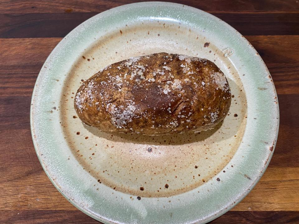 cooked baked potato on a kitchen plate