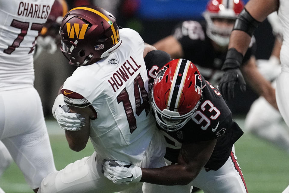 Washington Commanders quarterback Sam Howell (14) is hit after a pass by Atlanta Falcons defensive tackle Calais Campbell (93) during the first half of an NFL football game, Sunday, Oct. 15, 2023, in Atlanta. (AP Photo/John Bazemore)