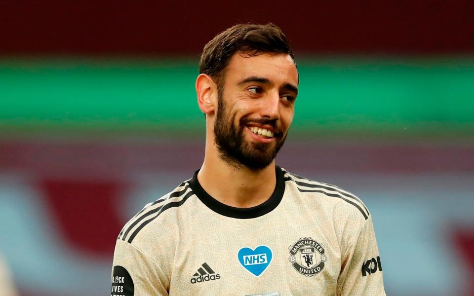 Manchester United's Portuguese midfielder Bruno Fernandes grins during the English Premier League football match between Aston Villa and Manchester United  - AFP