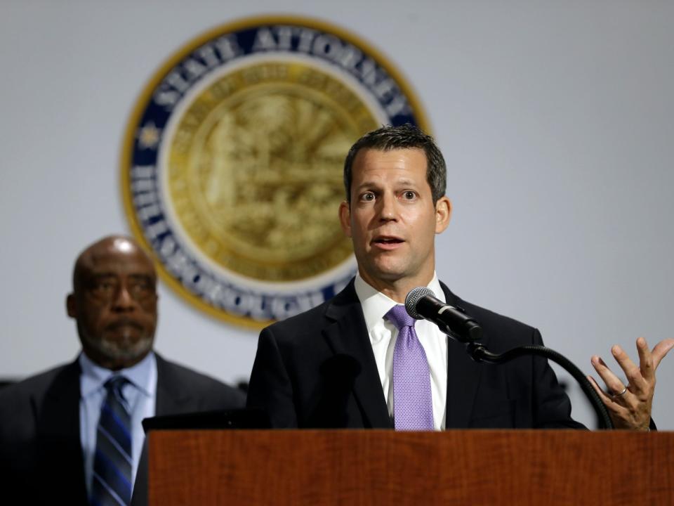 Hillsborough County State Attorney Andrew Warren, right, speaks during a news conference Monday, June 15, 2020, in Tampa, Fla. Warren announced his decision not to prosecute dozens of protesters arrested on charges of unlawful assembly during a Black Lives Matter march on June 2. Looking on is visionary leader Bishop Thomas Scott.