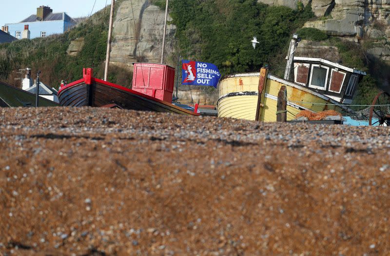 FILE PHOTO: A flag with a slogan supporting the UK fishing industry is seen on the beach in Hastings