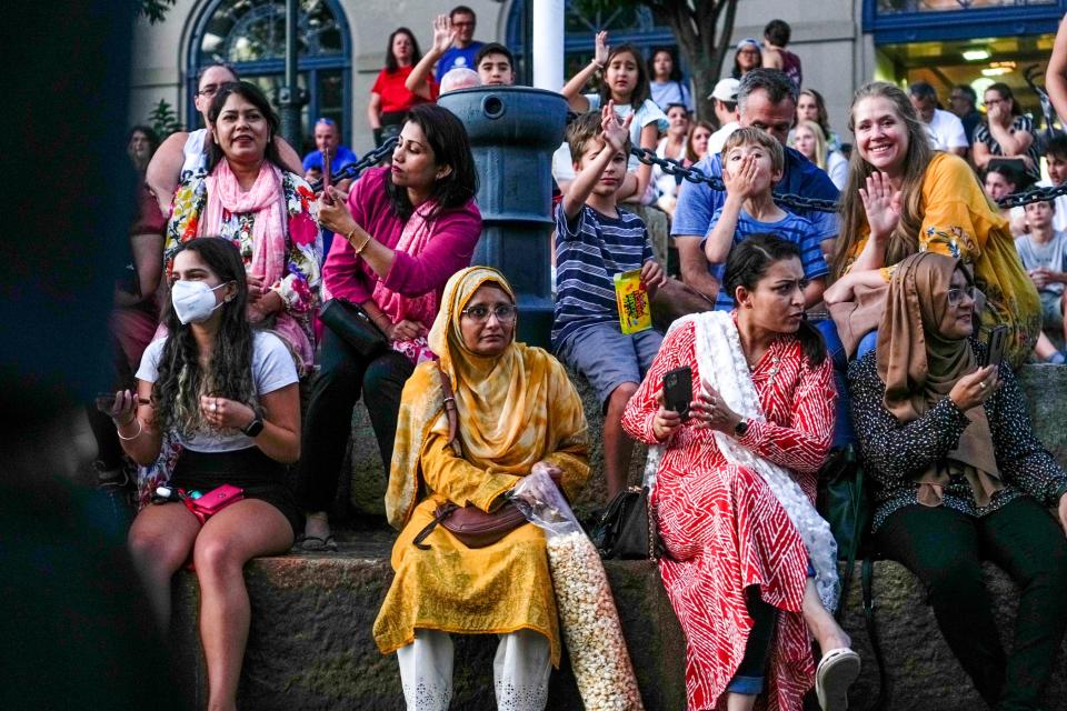 Spectators score riverfront seats while awaiting the WaterFire lighting.