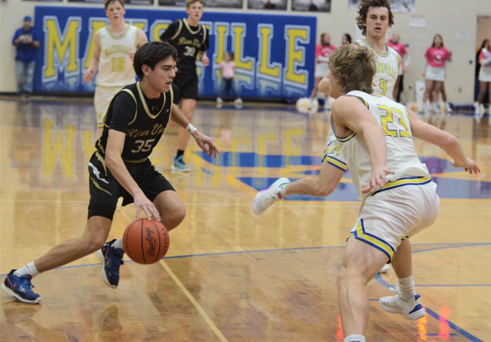 River View's Owen Emig tries to dribble past Maysville's Hayden Jarrett in Friday's MVL game. Emig became the program's all-time leading scorer, but the Black Bears fell 88-67.