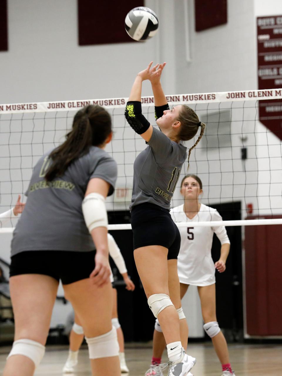 Kayla Dulgar sets the ball during River View's 25-22, 14-25, 25-17, 18-25, 7-15 loss to host John Glenn on Monday night in New Concord. 