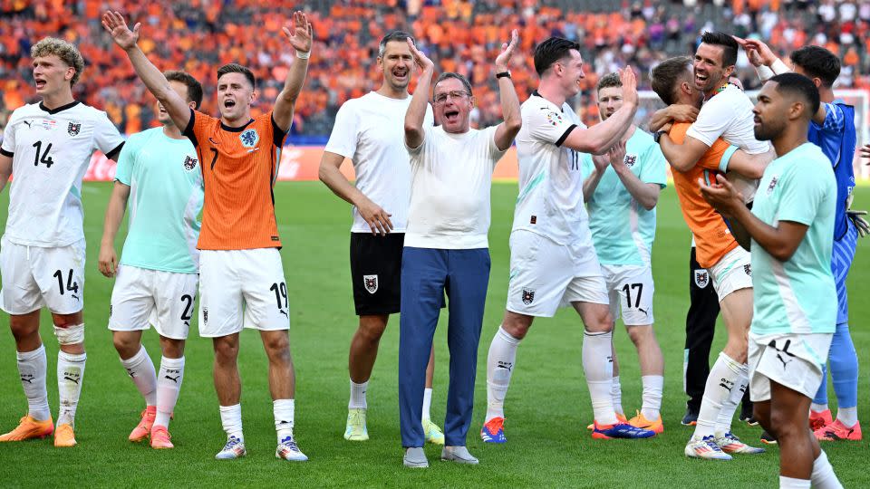 Austria coach Ralf Rangnick and players celebrate after beating the Netherlands. - Annegret Hilse/Reuters