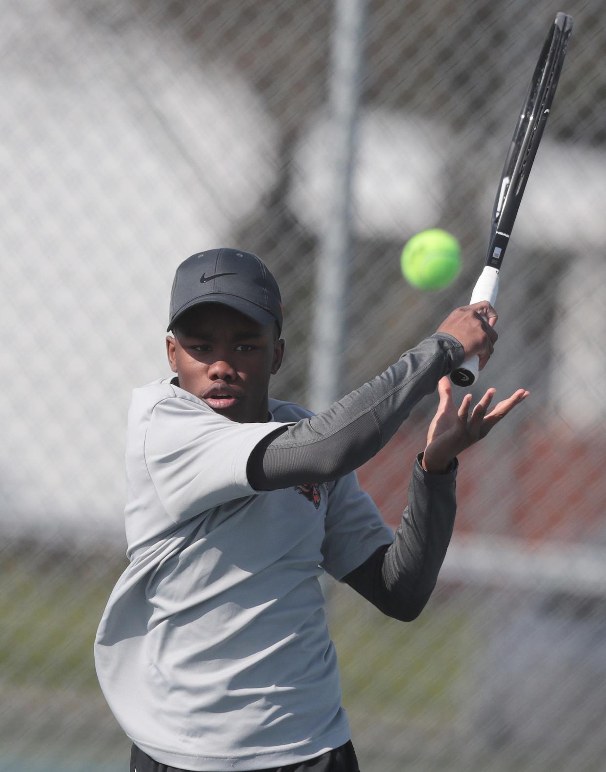 Hoover No. 2 singles player Hunter Holloway returns a shot from Perry's Ryan Linkie on Wednesday.