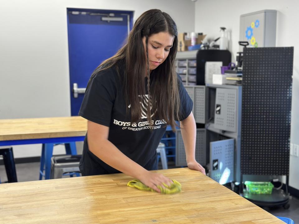 Addison Beer, 17, center, prepares for summer campers arriving next week at the Virginia G. Piper branch of the Boys & Girls Club where she works, Thursday, May, 25, 2023 in Scottsdale, Ariz. With the job market the tightest in half a century, younger workers are playing a critical role in kicking off the summer tourism season this Memorial Day weekend. (AP Photo/Alina Hartounian)