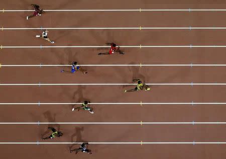 Usain Bolt of Jamaica (R) leads in the men's 200 metres final during the 15th IAAF World Championships at the National Stadium in Beijing, China, August 27, 2015. REUTERS/Pawel Kopczynski TPX IMAGES OF THE DAY